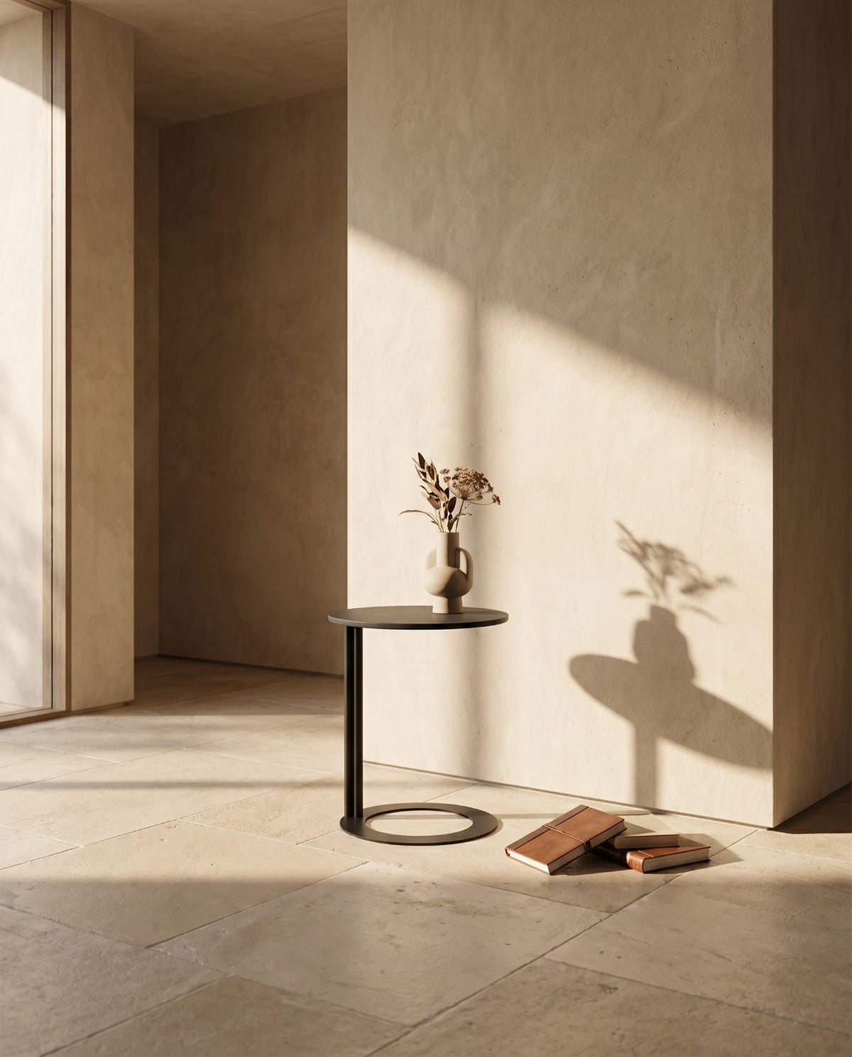 Lanott ST124 side table in Black Leather, lifestyle scene with a ceramic vase in a sunlit room