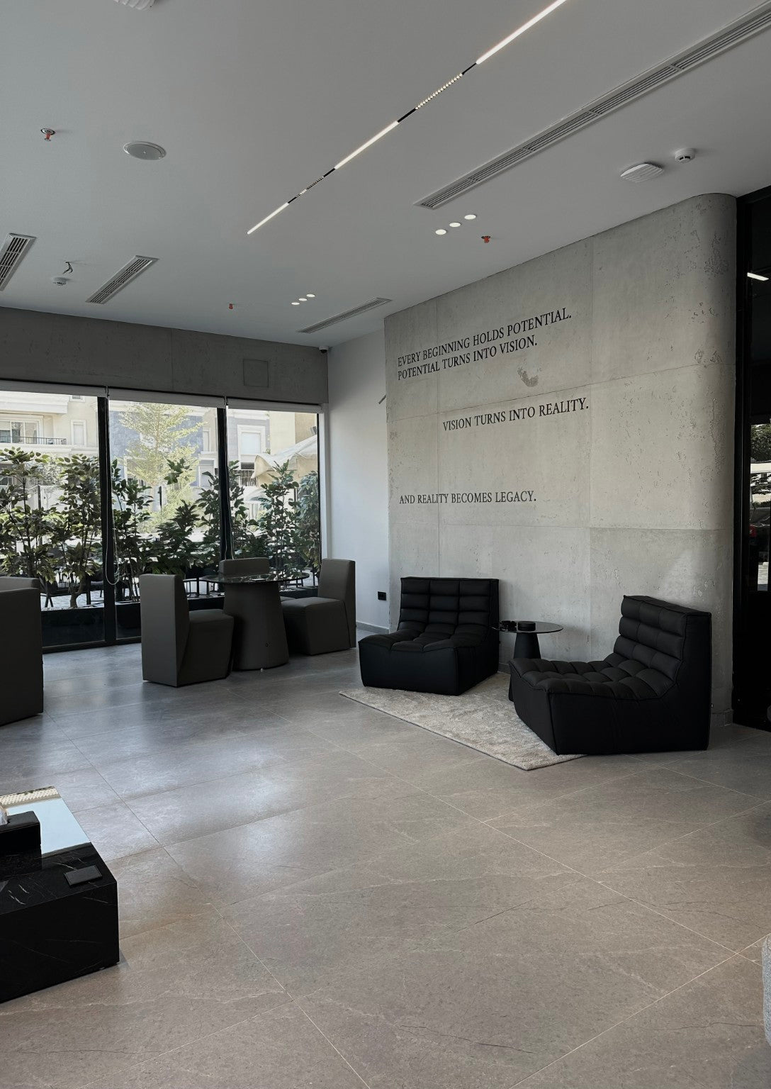 Black Lanott lounge chairs beside a dining area