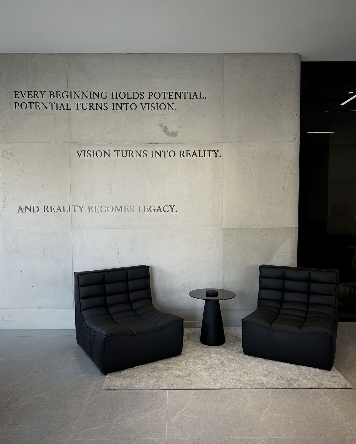 Lanott lounge chairs beneath the Imarrae wall quote