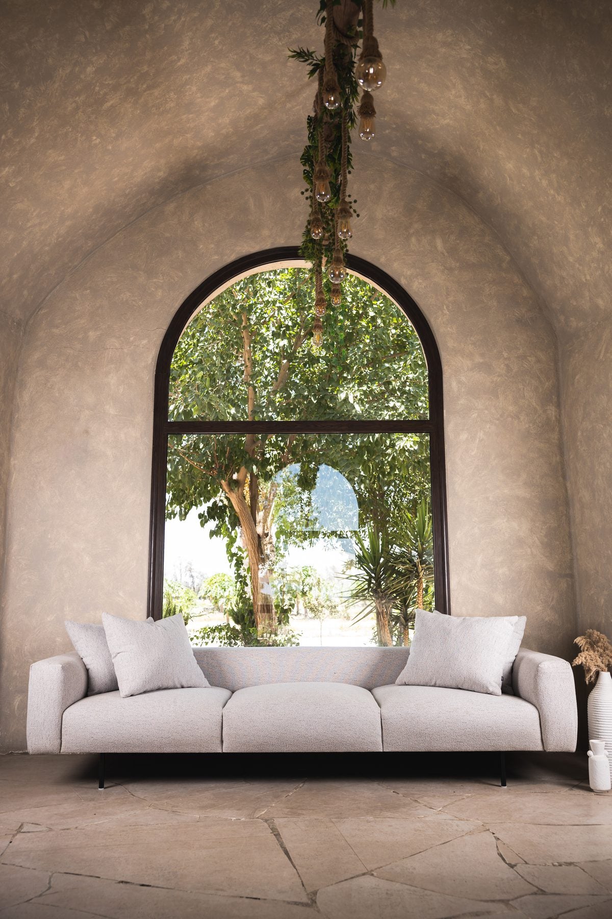 Lanott sofa beneath a round window