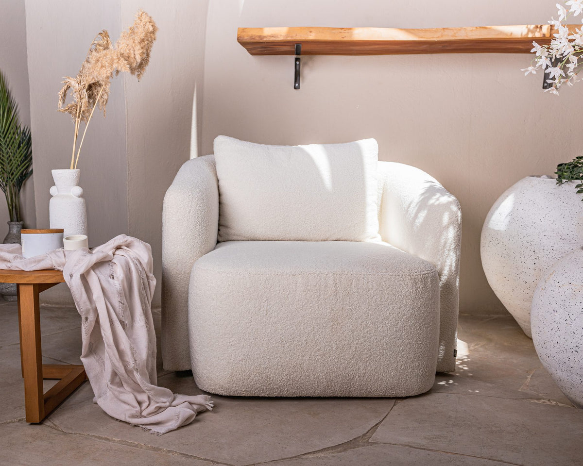 Lanott cream armchair with a soft throw