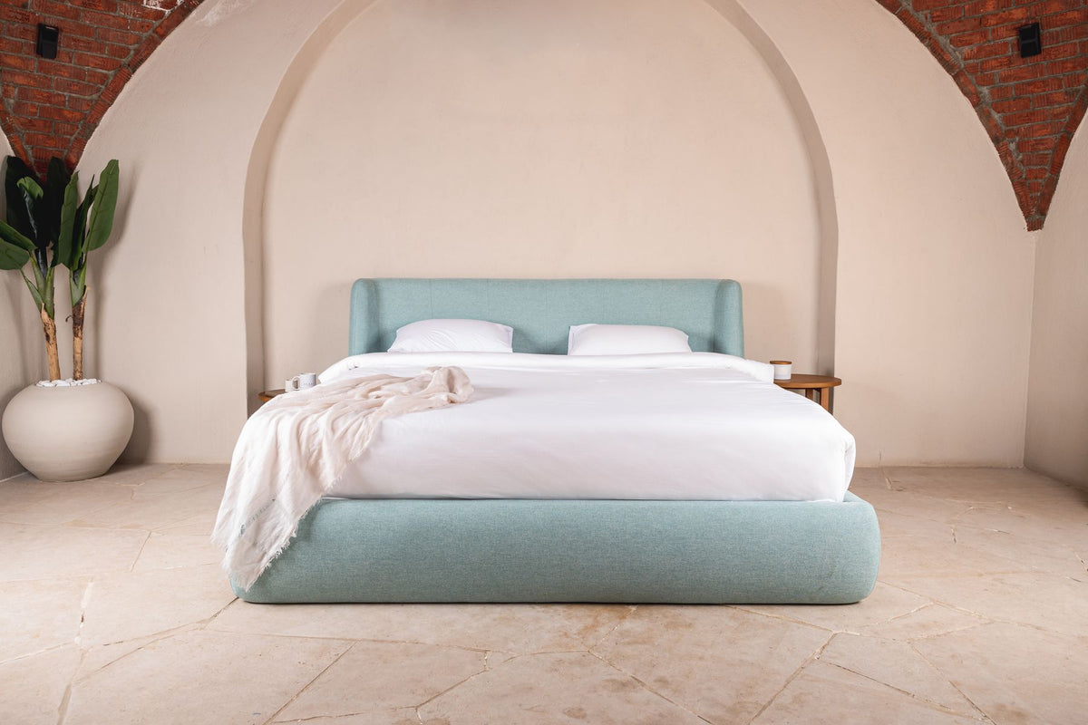 Lanott bed framed by a brick arch