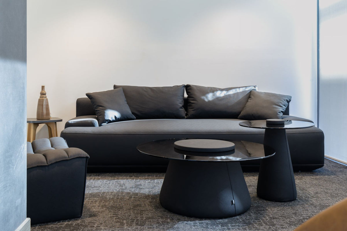 Lanott dark leather sofa with round coffee tables