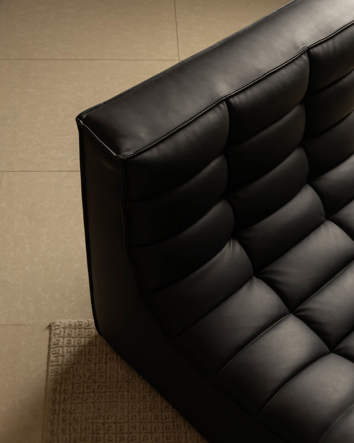 Black quilted leather armchair