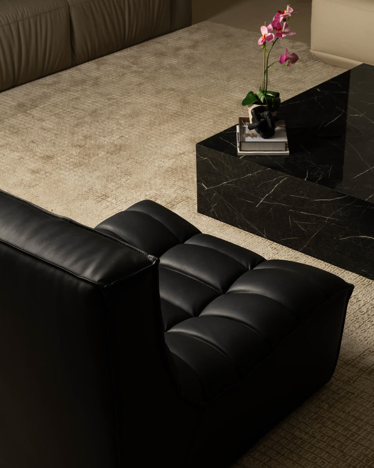 Black leather sofa with a marble table