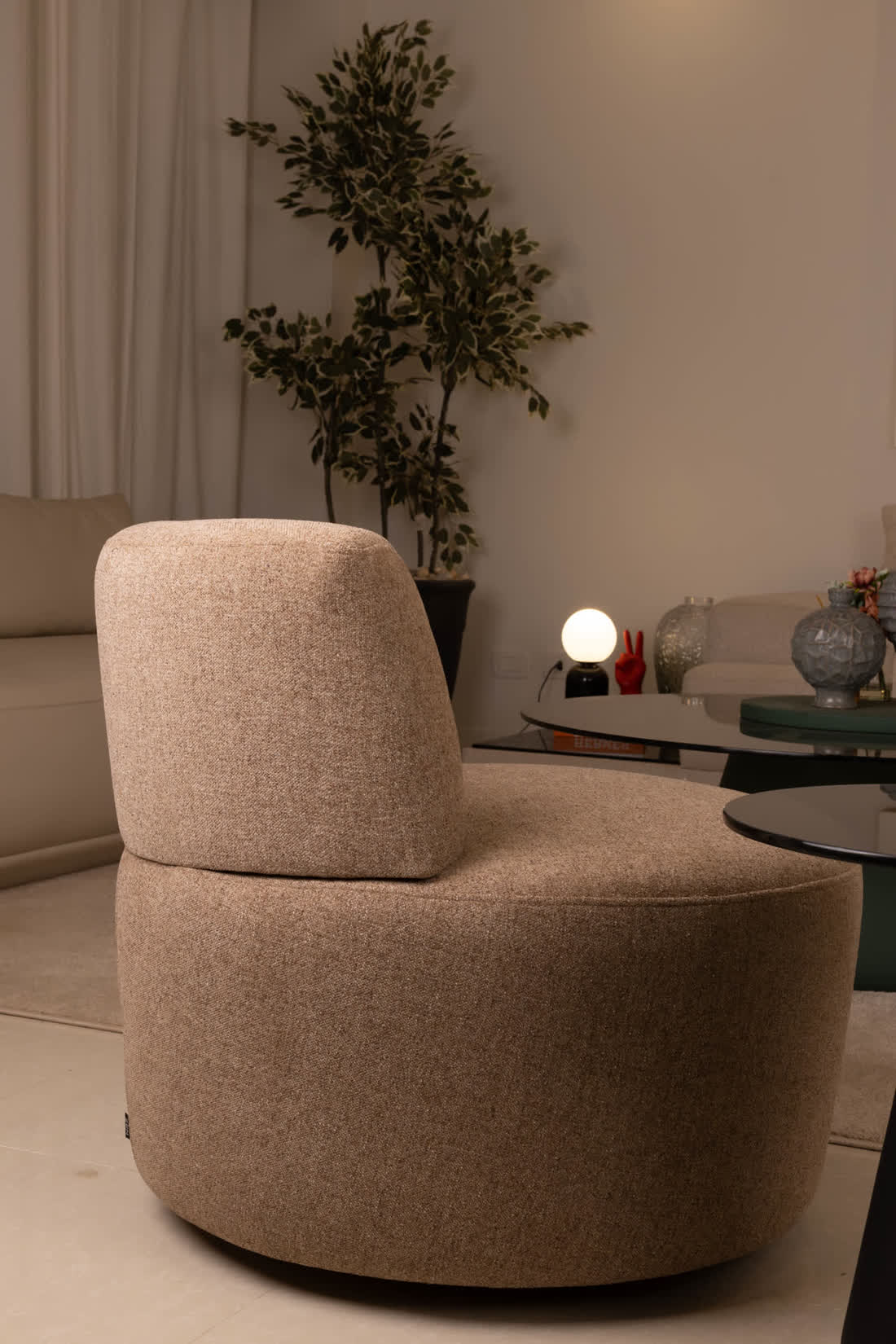 Boucle swivel armchair in a corner