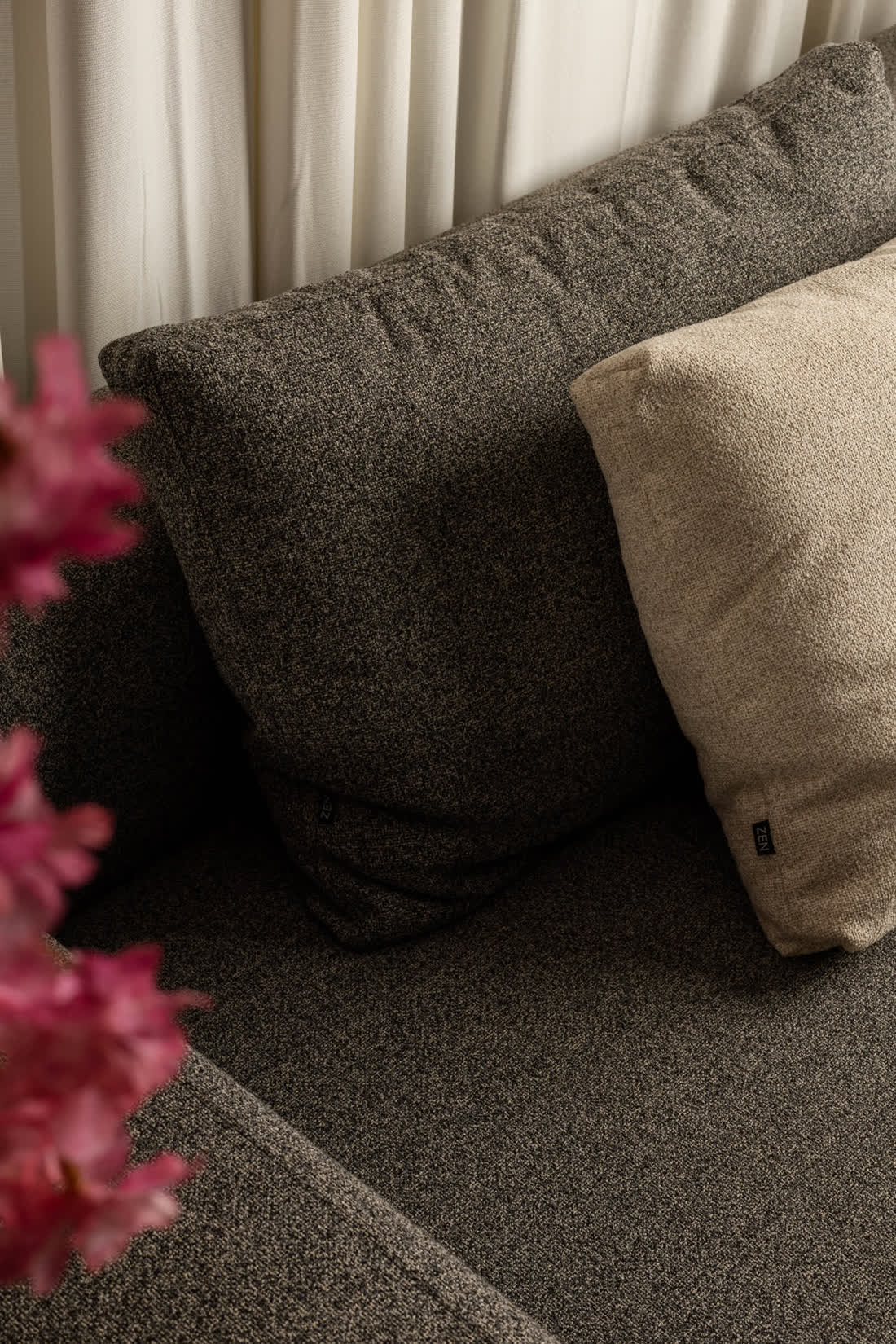 Grey sofa styled with blossom branches