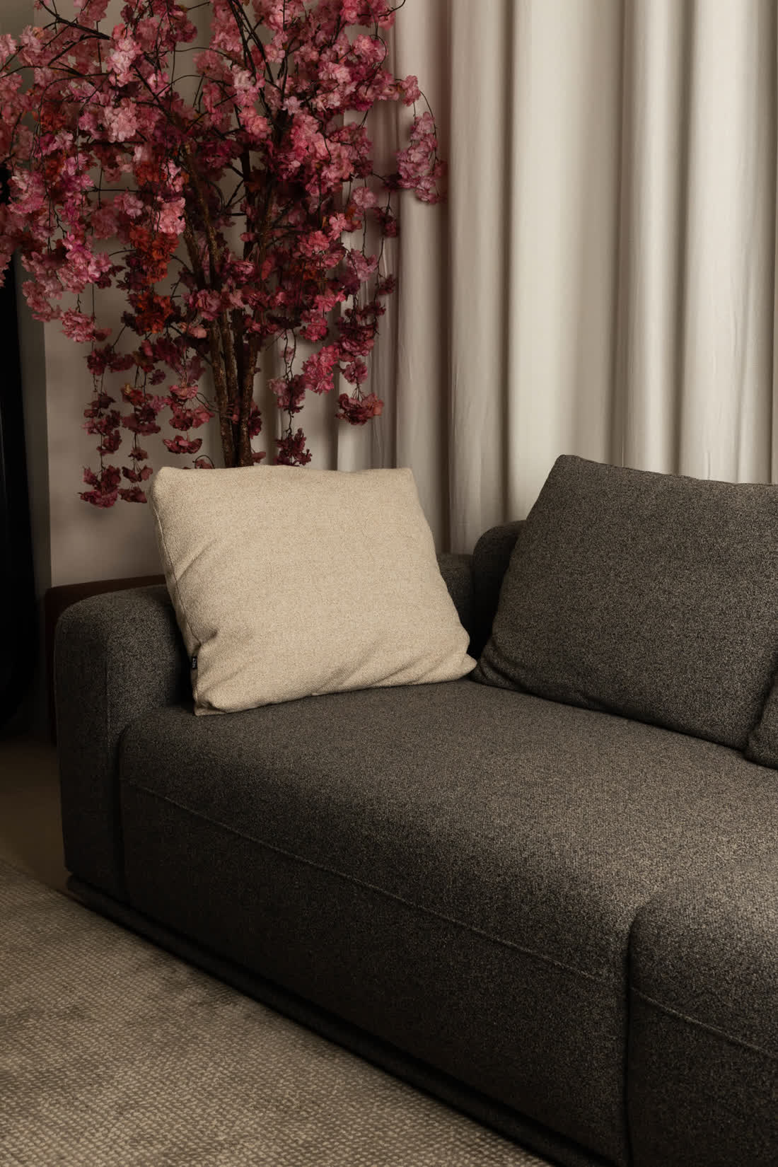 Grey fabric sofa with cushion detail